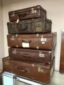 Five vintage leather suitcases