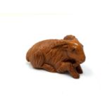 A carved Chinese hardwood netsuke - Goat lying down