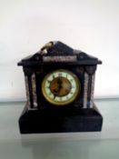 A late Victorian slate mantel clock with enamelled dial