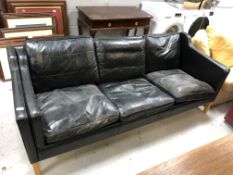 A twentieth century Continental Stouby three seater black leather settee