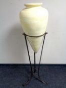 A contemporary conical form pottery vase on metal stand