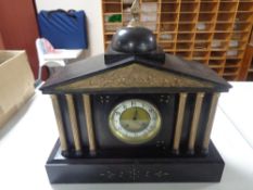 A late 19th century black slate mantel clock with column supports,