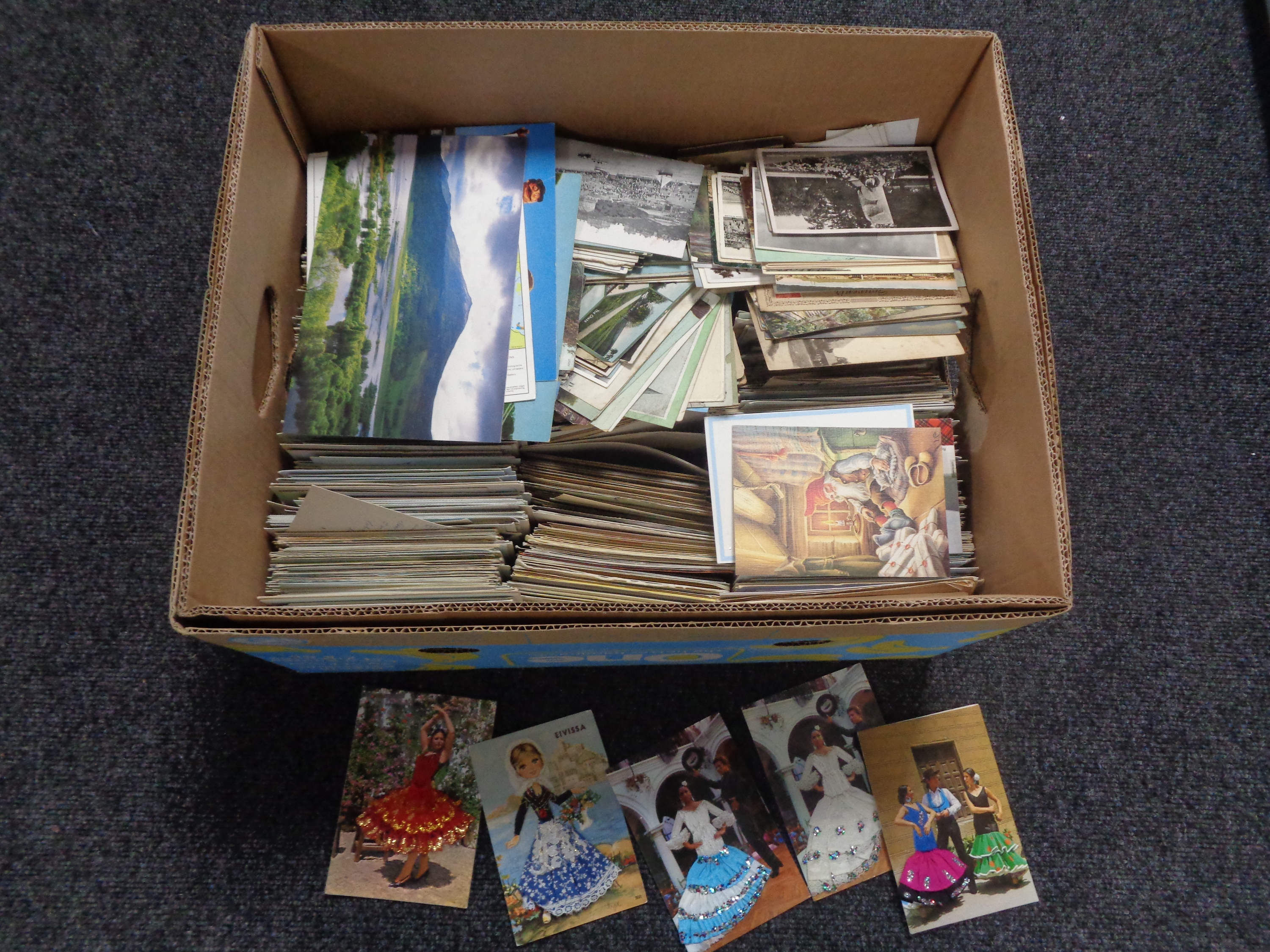 A box containing a large quantity of old and modern postcards including Spanish silks