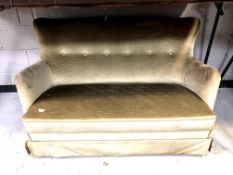 A Continental two seater settee in green buttoned upholstery