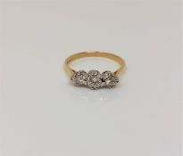 An 18ct gold three stone diamond ring, size N CONDITION REPORT: 2.