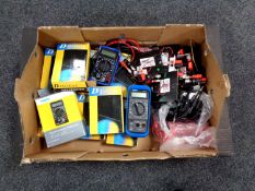 A box containing a quantity of boxed and unboxed digital multimeters