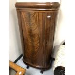 A Continental mahogany D-shaped single door cabinet