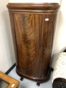 A Continental mahogany D-shaped single door cabinet