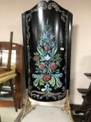 A painted metal convex fire screen