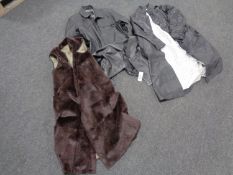 A box containing three assorted black leather jackets and a fur coat