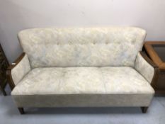 A Continental three seater settee in buttoned upholstery