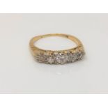 An antique gold five stone diamond ring, size O CONDITION REPORT: 3.8g. Marks worn.