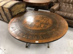 A large Continental copper topped circular coffee table on metal base