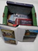 A box containing five albums of 20th century postcards