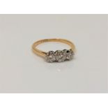 An 18ct gold three stone diamond ring, size M CONDITION REPORT: 2.