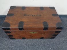 A wooden metal bound storage chest marked "bottles"