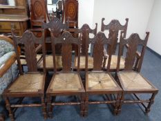A set of seven carved beech high back kitchen dining chairs with rattan seats,