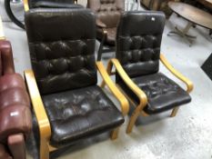 A pair of twentieth century beech framed brown leather upholstered armchairs (af)