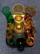 A tray containing a quantity of green and amber glassware