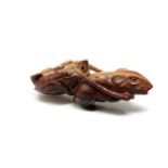 A carved Chinese hardwood netsuke - Rat pulling a turtle