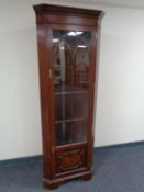 A reproduction glazed mahogany corner cabinet