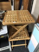 A pair of folding teak lattice tables