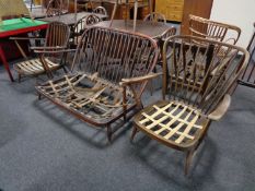 An Ercol three piece spindle backed lounge suite comprising two armchairs and two seater settee