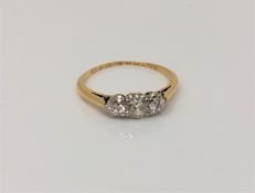 An antique 18ct gold three stone diamond ring, approx. 0.