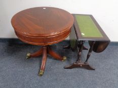 A reproduction mahogany drum table together with a leather topped flap sided table