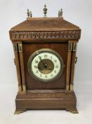 An Edwardian oak bracket clock with gilt brass mounts and enamel dial,