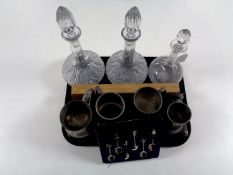 A tray containing three cut glass decanters with stoppers,