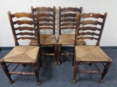 A set of four beech ladder back kitchen chairs with rattan seats