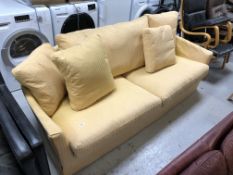 A twentieth century three seater settee in yellow striped upholstery