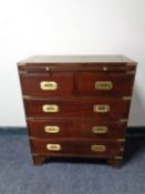 A ship's style narrow five drawer chest with slide and tooled leather inset panel