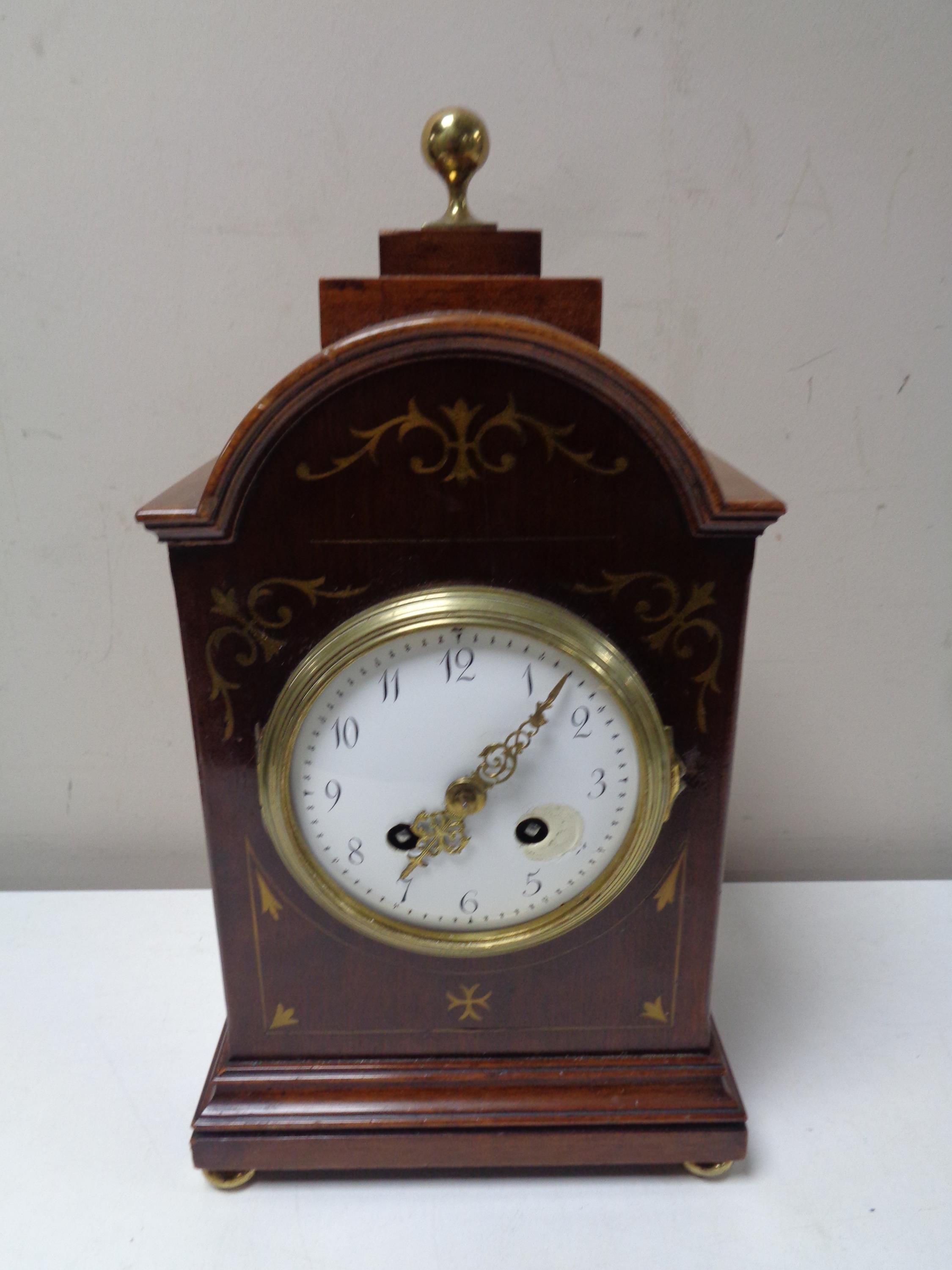 An Edwardian inlaid mahogany bracket clock with enamel dial,