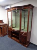 A late Victorian inlaid mahogany triple door display cabinet with bowfront central drawer fitted