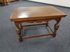 An oak pull out coffee table on bulbous legs