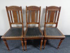 A set of three early 20th century oak dining chairs