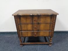 A carved beech serpentine front three drawer chest on raised legs