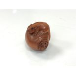 A carved Chinese hardwood netsuke - Two rats on a pot