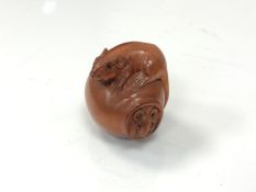 A carved Chinese hardwood netsuke - Two rats on a pot