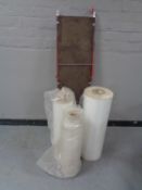 A decorators platform together with three rolls of polythene