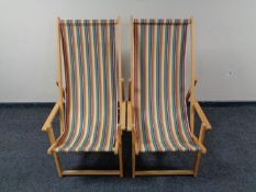 A pair of folding striped deck chairs