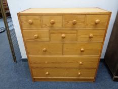 A pine fronted eleven drawer chest