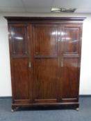 An Edwardian mahogany triple door wardrobe