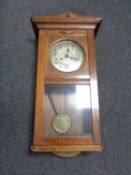 A 20th century cased eight day wall clock with silvered dial