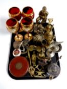 A tray containing assorted brass ornaments, hand bells, vintage tape measure,