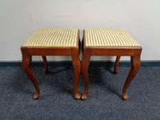 A pair of 20th century mahogany dressing table stools