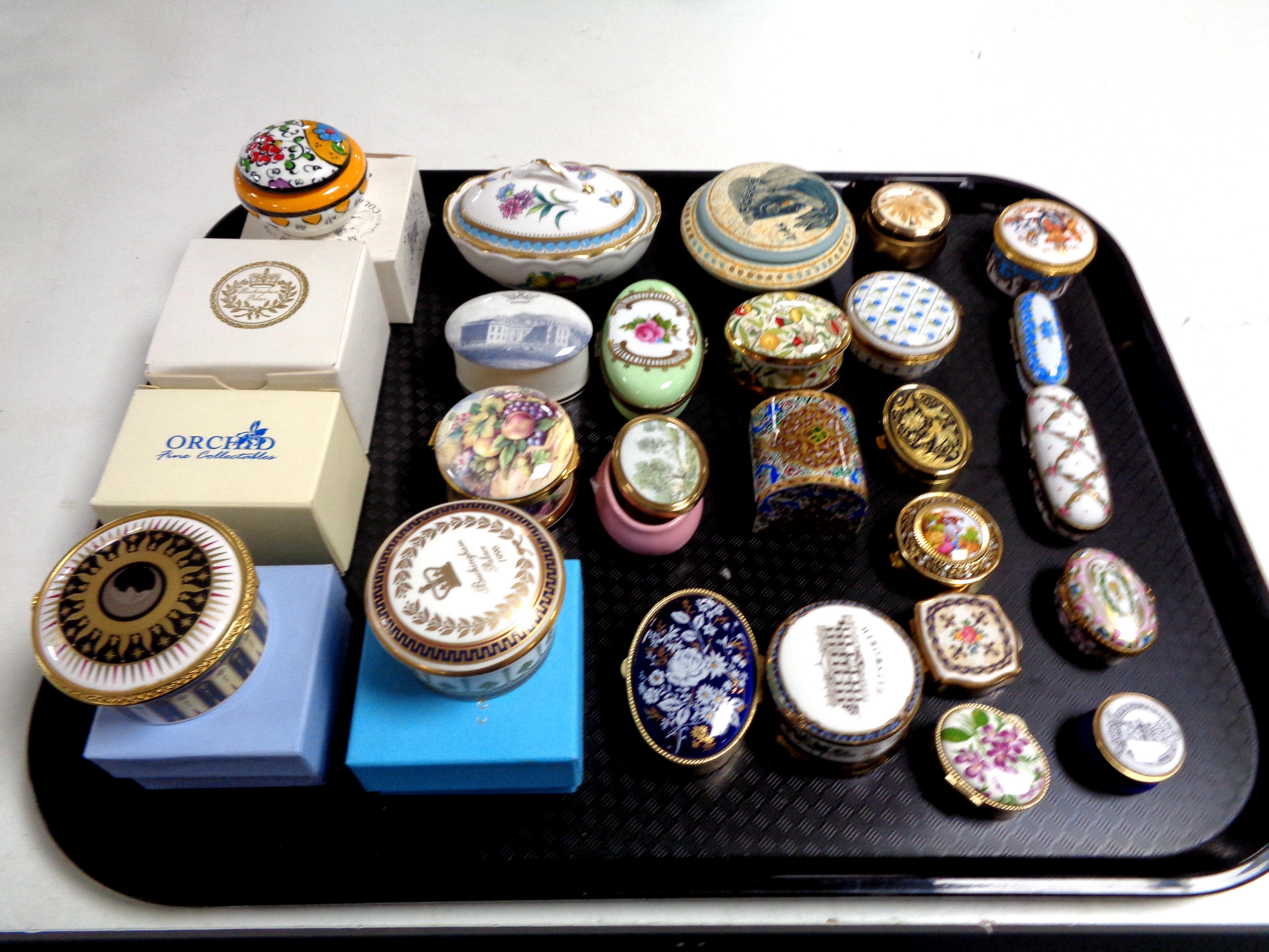 A tray of pill boxes and lidded trinket dishes