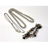 A silver curb link necklace, an unusual pearl bracelet and a pearl necklace.